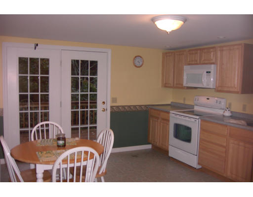 15 Newcomb Road Westminster, MA 01473 - Photo 3 of 6 a kitchen with stainless steel appliances granite countertop a stove a sink a refrigerator and cabinets
