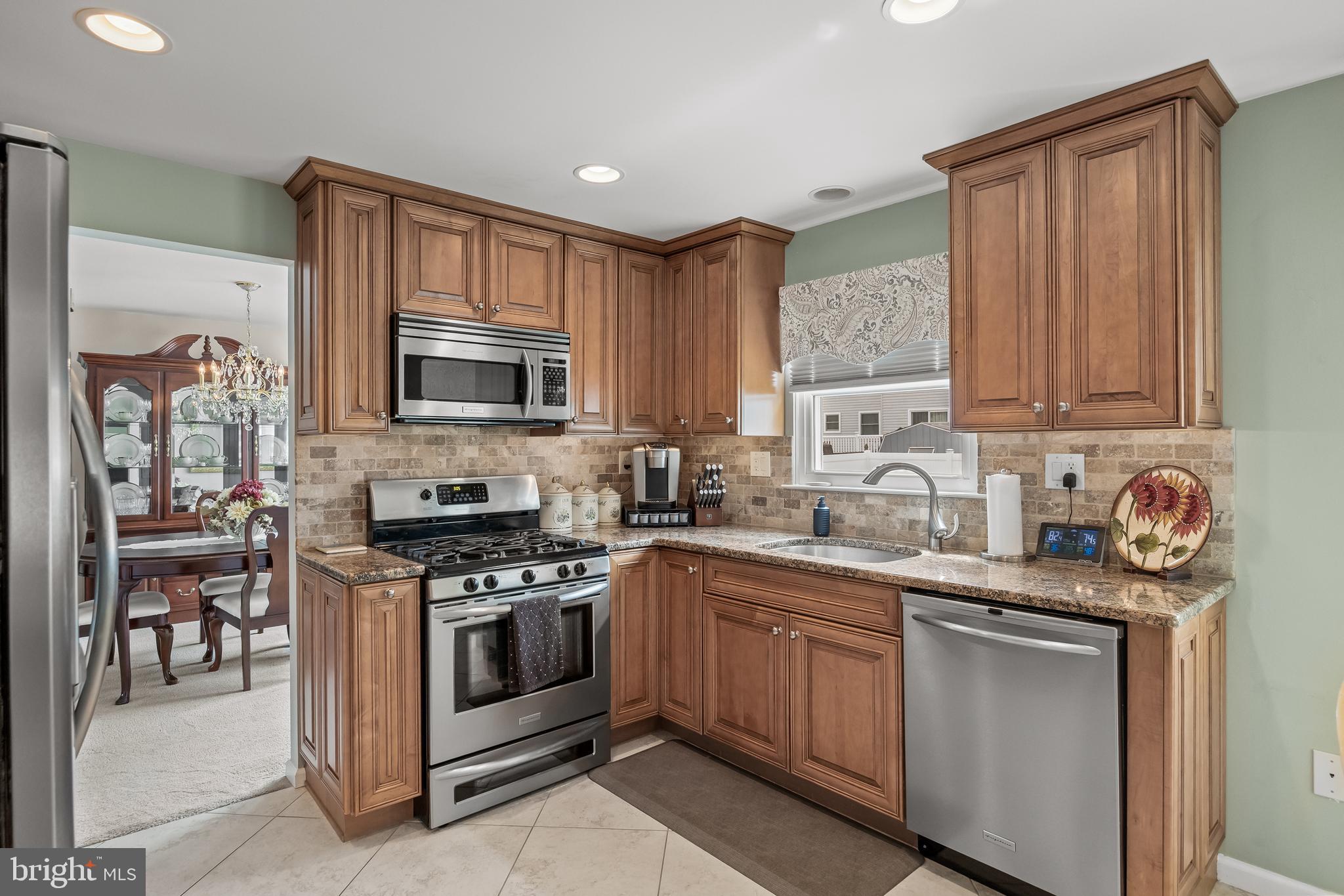 52 Yale Road Marlton, NJ 08053 - Photo 12 of 39 a kitchen with stainless steel appliances granite countertop a stove top oven a sink dishwasher and a microwave oven on the blue kitchen countertops