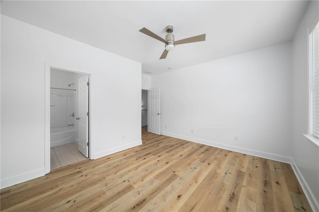 3628 Ashcroft Bend Atlanta, GA 30319 - Photo 34 of 44 an empty room with wooden floor and windows