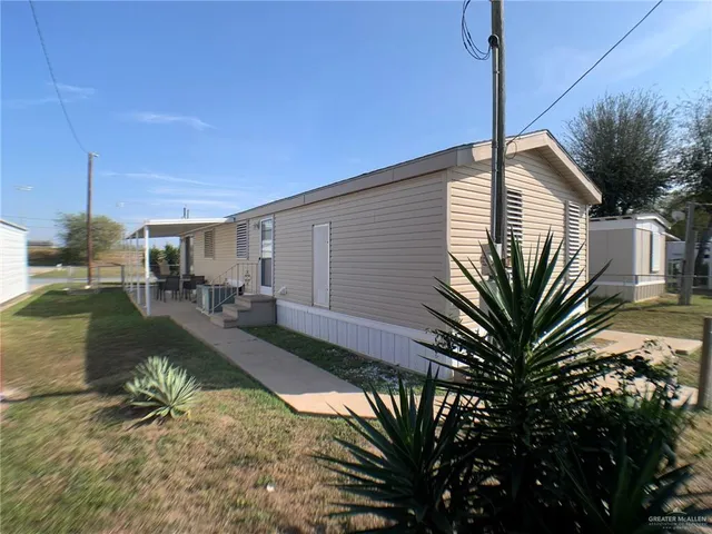 a house view with a sitting space and garden space