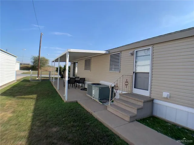 a view of a patio with table and chairs a barbeque with wooden fence