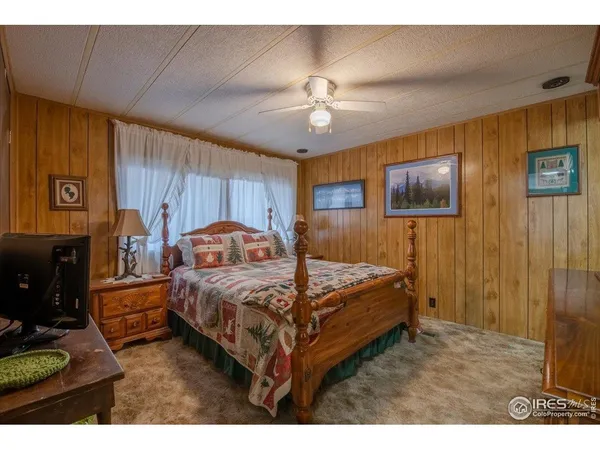 a bed room with a bed and a chandelier
