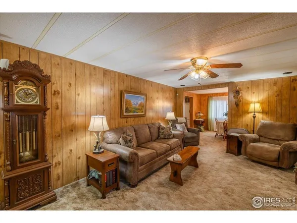 a living room with furniture and a lamp