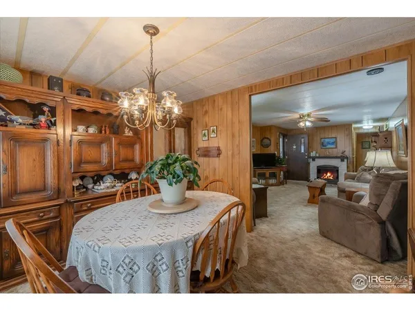 a dining room with furniture and chandelier