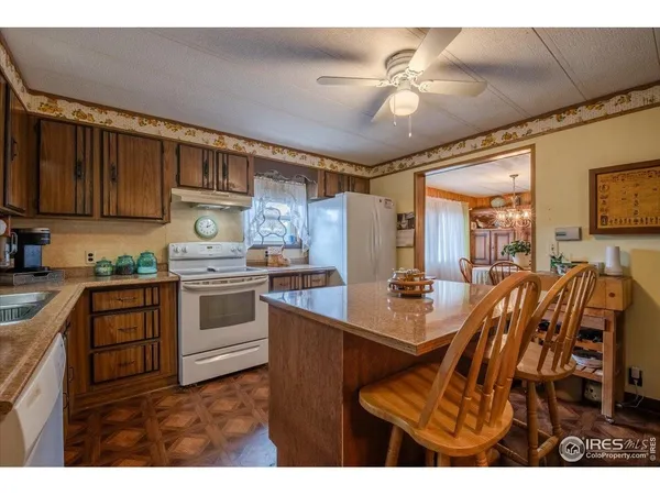 a view of kitchen with cabinets and window