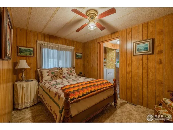 a bed room with a bed and mirror