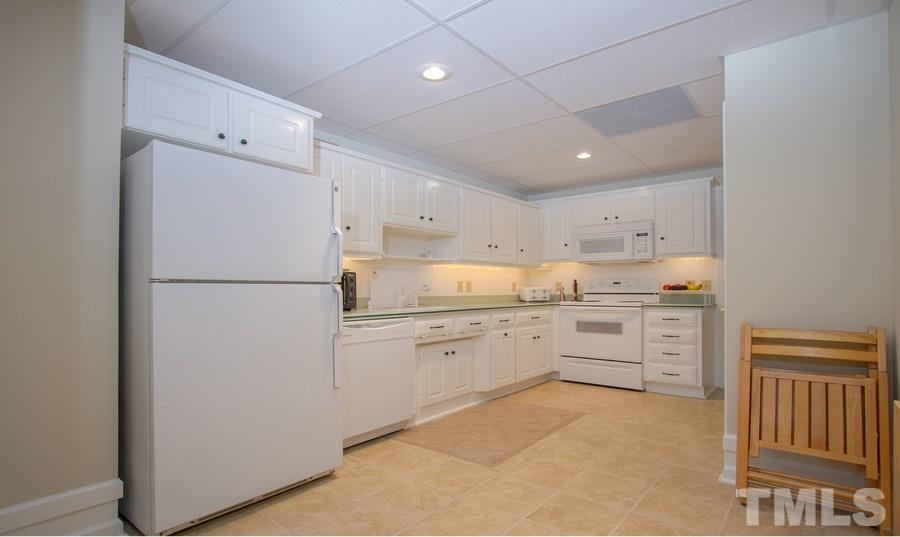 5508 Watkins Road Wendell, NC 27591 - Photo 21 of 25 a kitchen with white cabinets and white appliances
