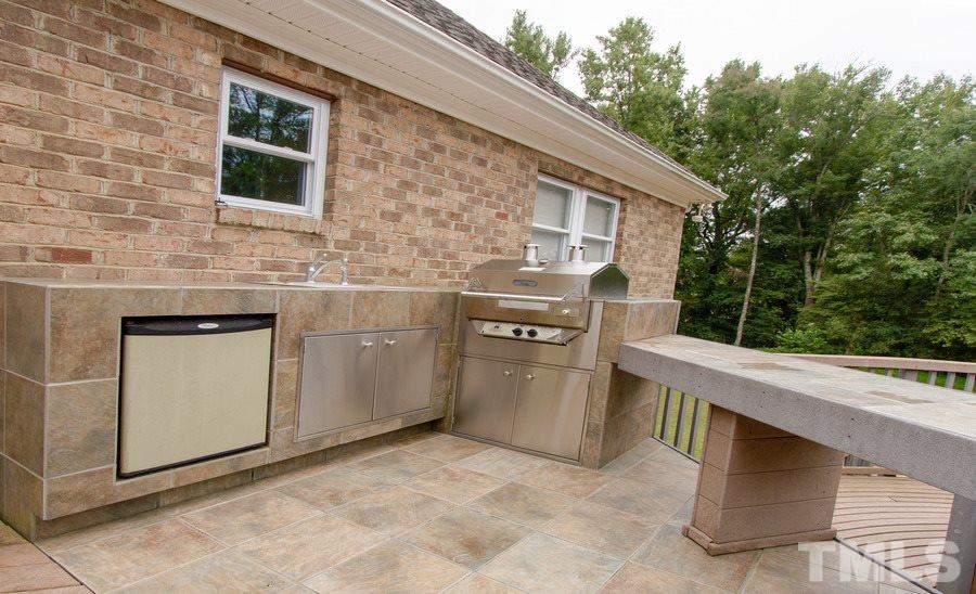 5508 Watkins Road Wendell, NC 27591 - Photo 24 of 25 a kitchen with stainless steel appliances granite countertop a stove a sink and a microwave