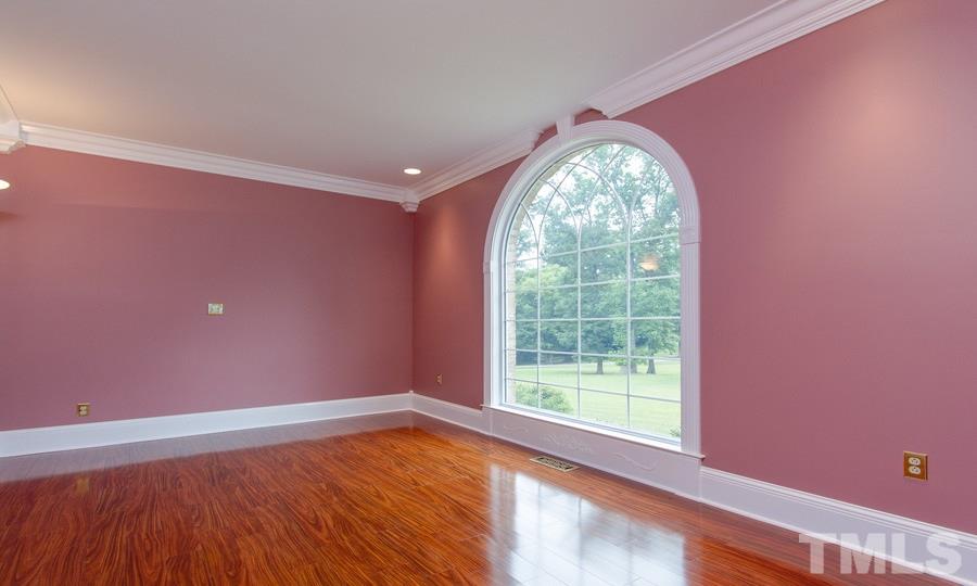 5508 Watkins Road Wendell, NC 27591 - Photo 4 of 25 a view of empty room with wooden floor and fan