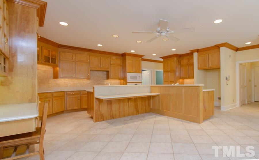 5508 Watkins Road Wendell, NC 27591 - Photo 8 of 25 a large kitchen with a large counter top a sink stainless steel appliances and cabinets