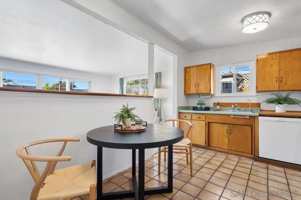 856 Oneonta Avenue Imperial Beach, CA 91932 - Photo 11 of 34 a kitchen with stainless steel appliances a white table and chairs in it