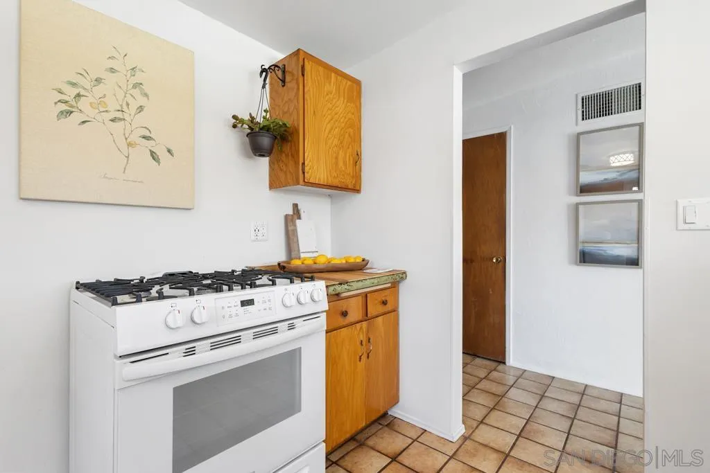 856 Oneonta Avenue Imperial Beach, CA 91932 - Photo 14 of 34 a white stove top oven sitting inside of a kitchen