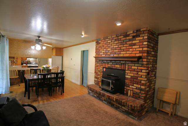 1612 East 450 South Springville, UT 84663 - Photo 14 of 48 Brick fireplace with a wood-burning insert and a wood mantel