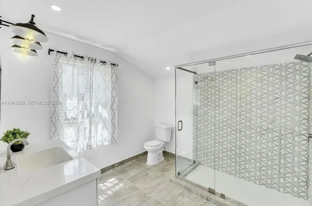 a bathroom with a shower and a toilet