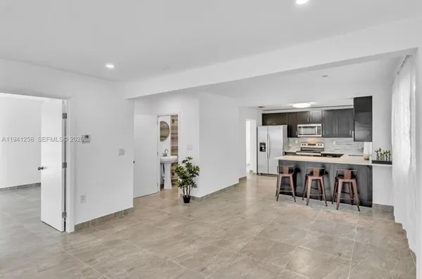 a view of kitchen with furniture and refrigerator