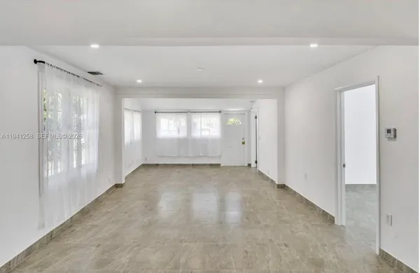 a view of an empty room and a window