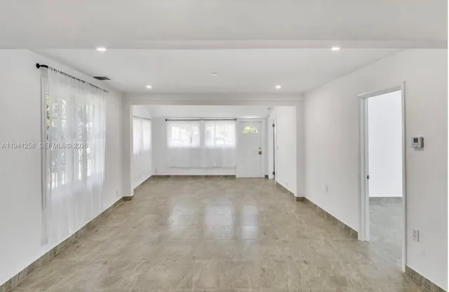 a view of an empty room and a window