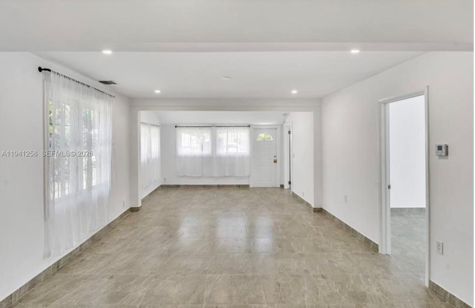 211 Southeast 9th Street Hallandale Beach, FL 33009 - Photo 4 of 16 a view of an empty room and a window