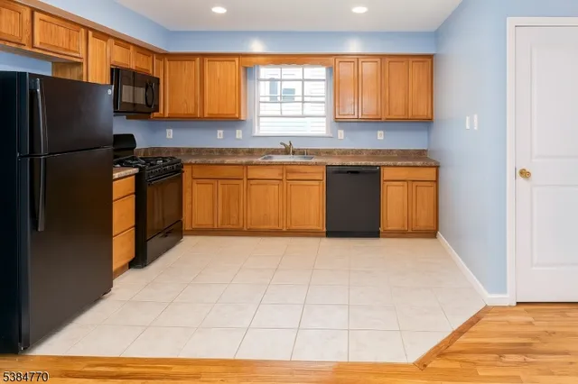 a kitchen with stainless steel appliances granite countertop a refrigerator sink and cabinets