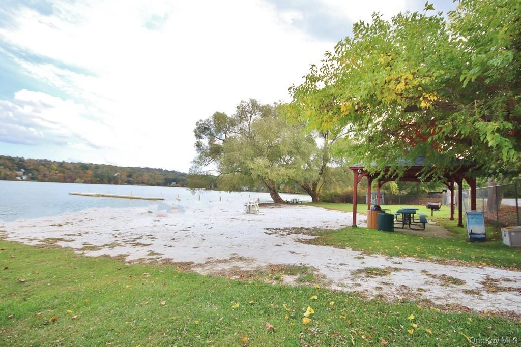 235 Haviland Drive Patterson, NY 12563 - Photo 18 of 18 a backyard of a house with large trees and outdoor seating