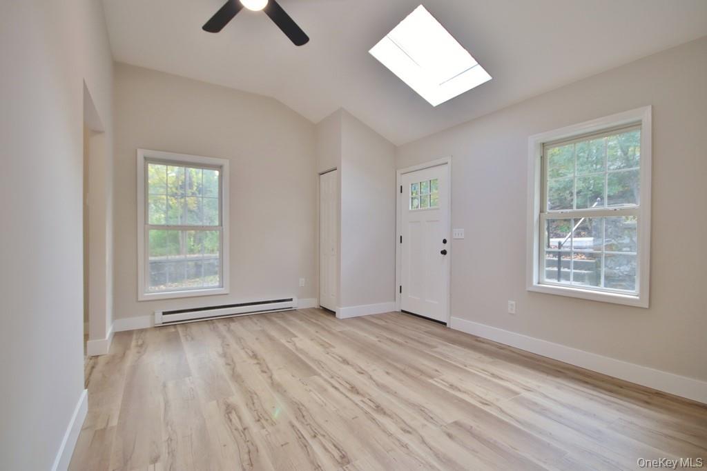 235 Haviland Drive Patterson, NY 12563 - Photo 7 of 18 a view of an empty room with wooden floor and a window