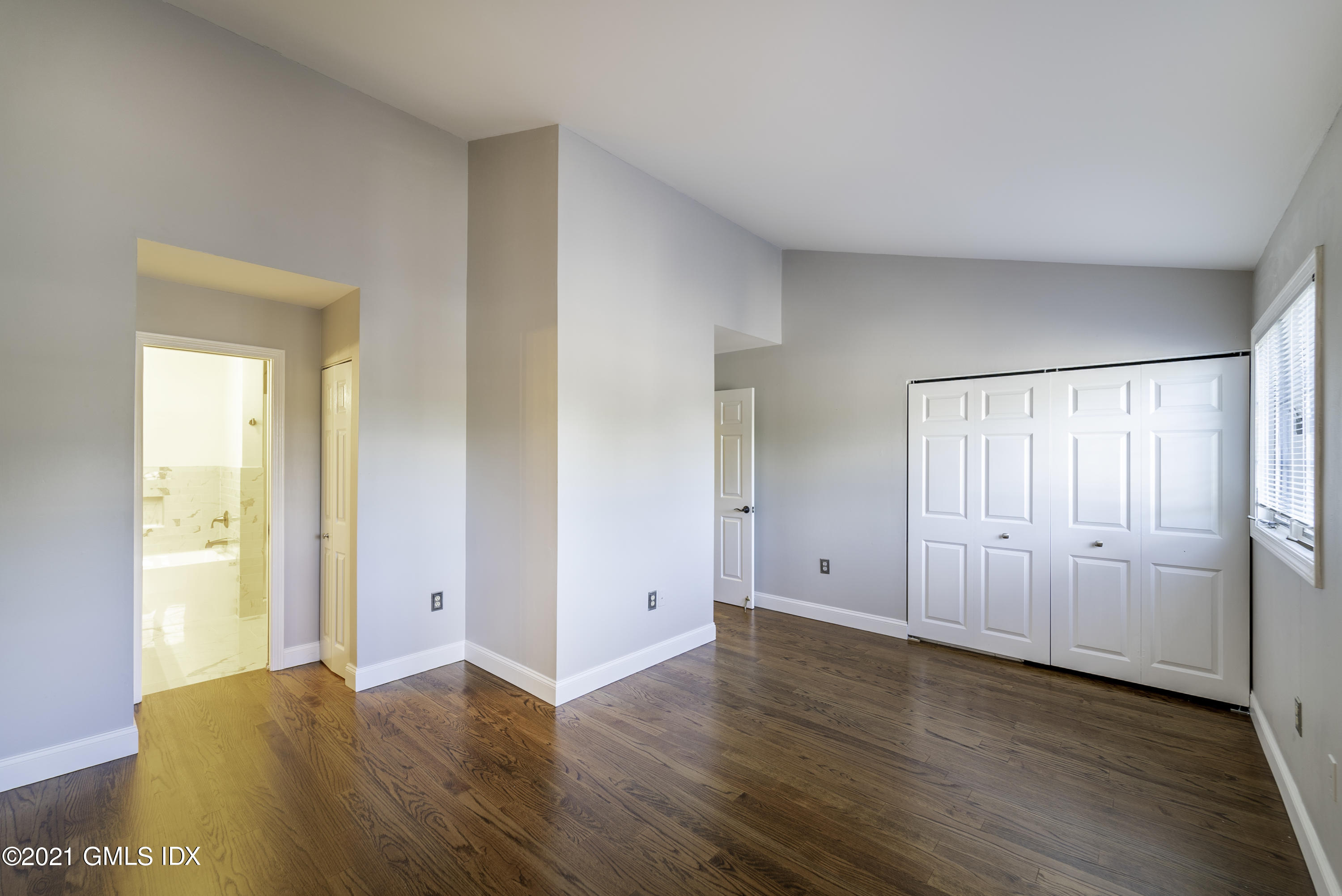 150 Prospect Street, Unit 23 Greenwich, CT 06830 - Photo 11 of 20 a view of room with window and wooden floor
