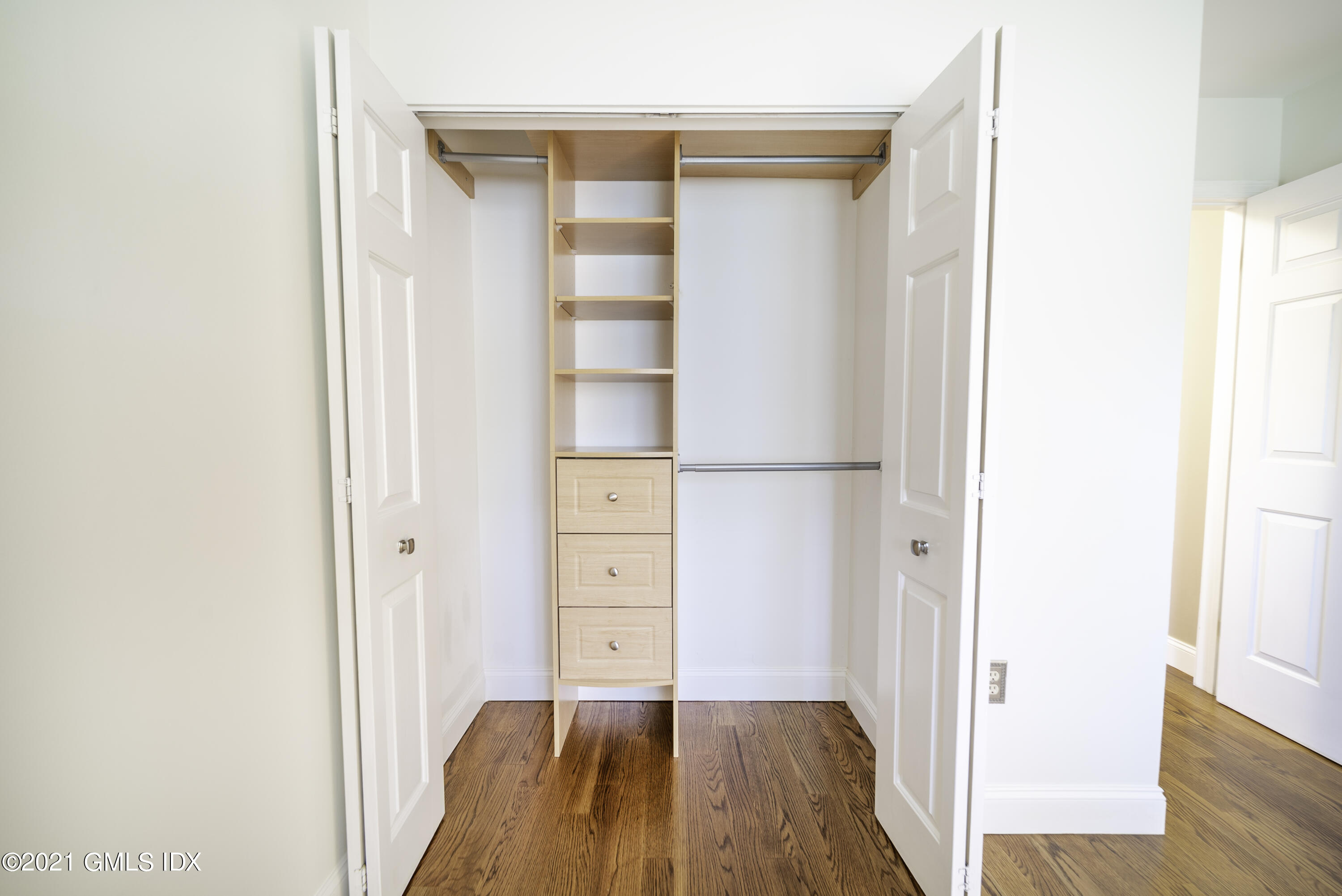 150 Prospect Street, Unit 23 Greenwich, CT 06830 - Photo 13 of 20 a view of walk in closet with wooden floor