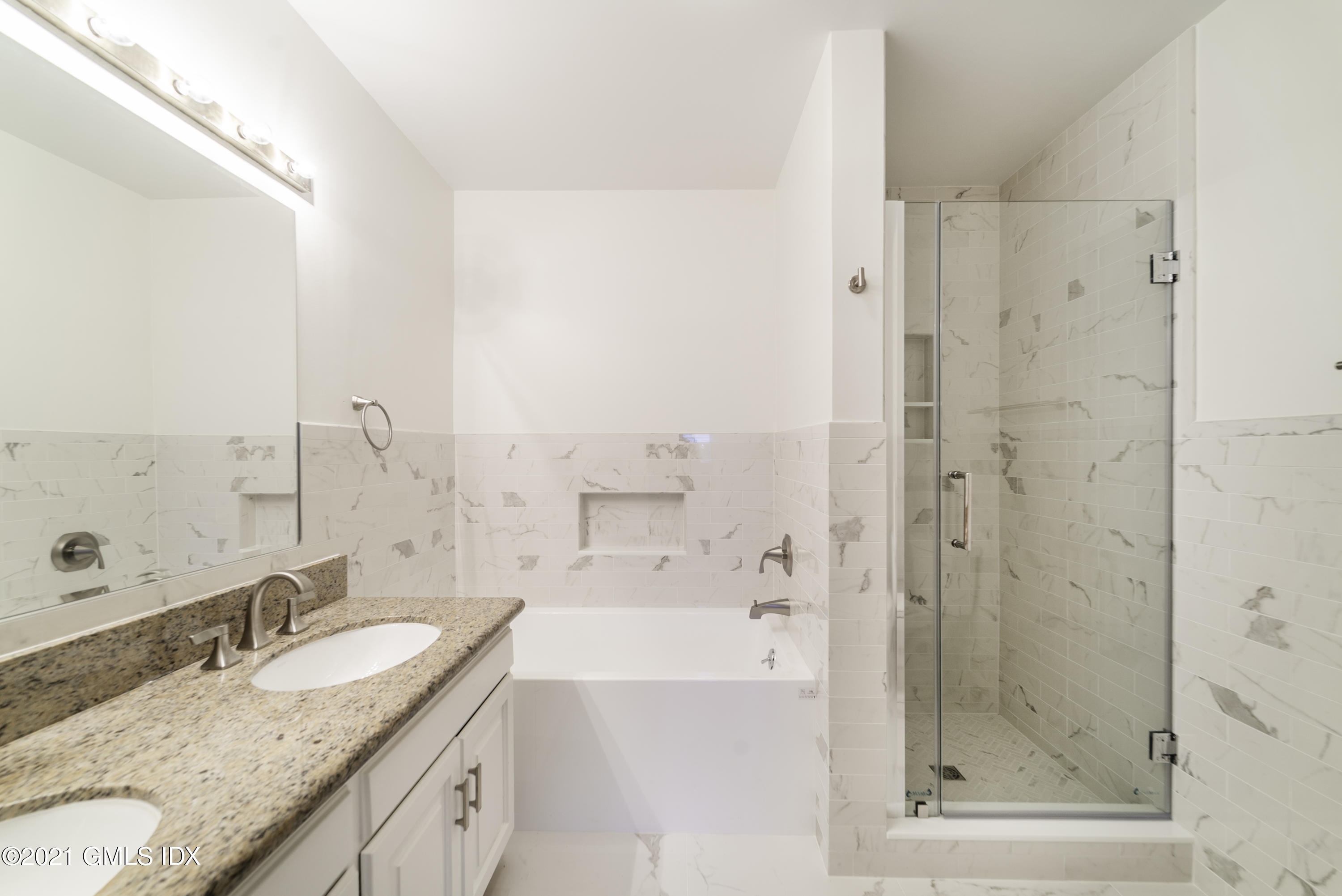 150 Prospect Street, Unit 23 Greenwich, CT 06830 - Photo 14 of 20 a bathroom with a granite countertop sink mirror and shower