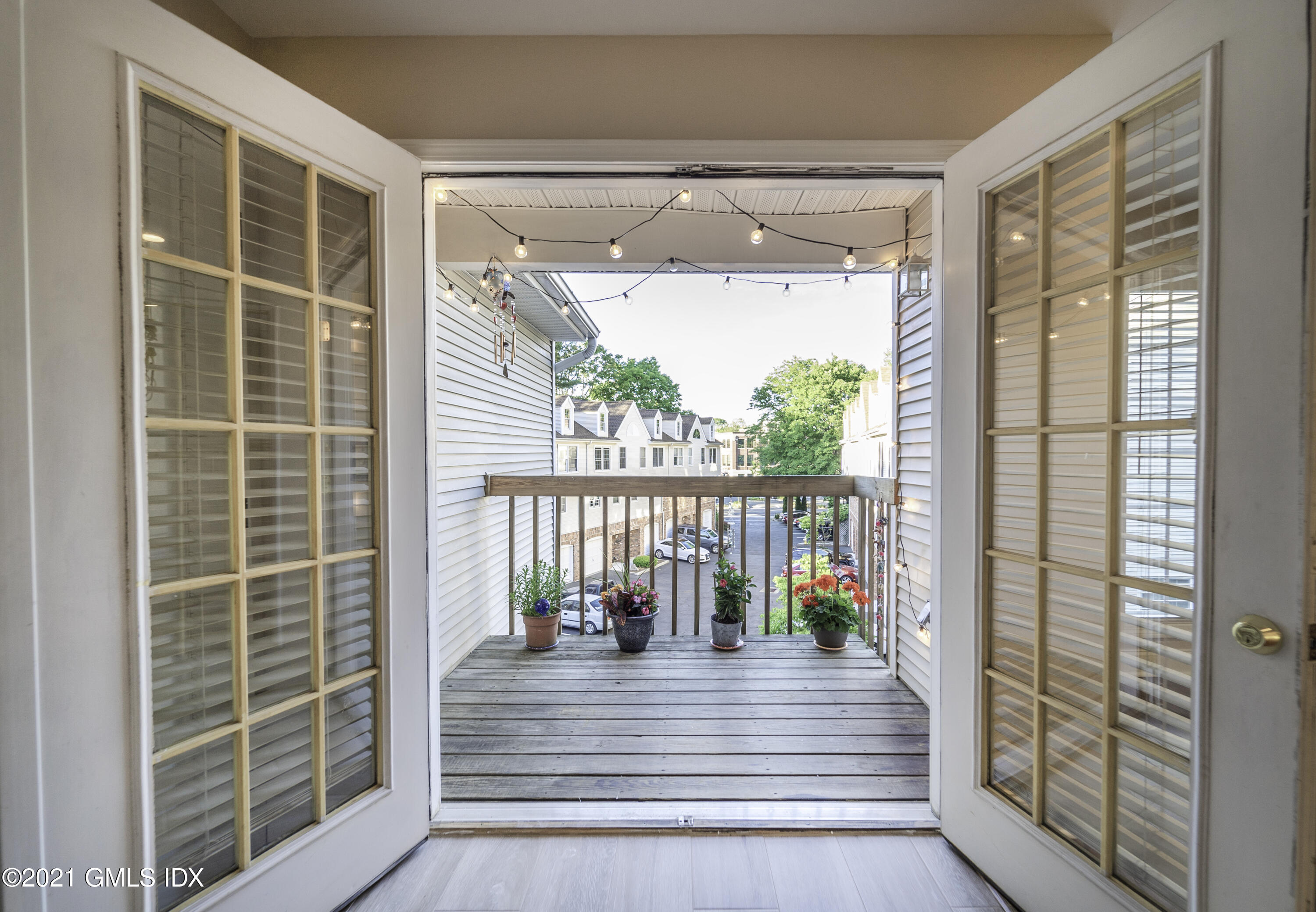 150 Prospect Street, Unit 23 Greenwich, CT 06830 - Photo 4 of 20 a view of a balcony with floor to ceiling windows and wooden floor