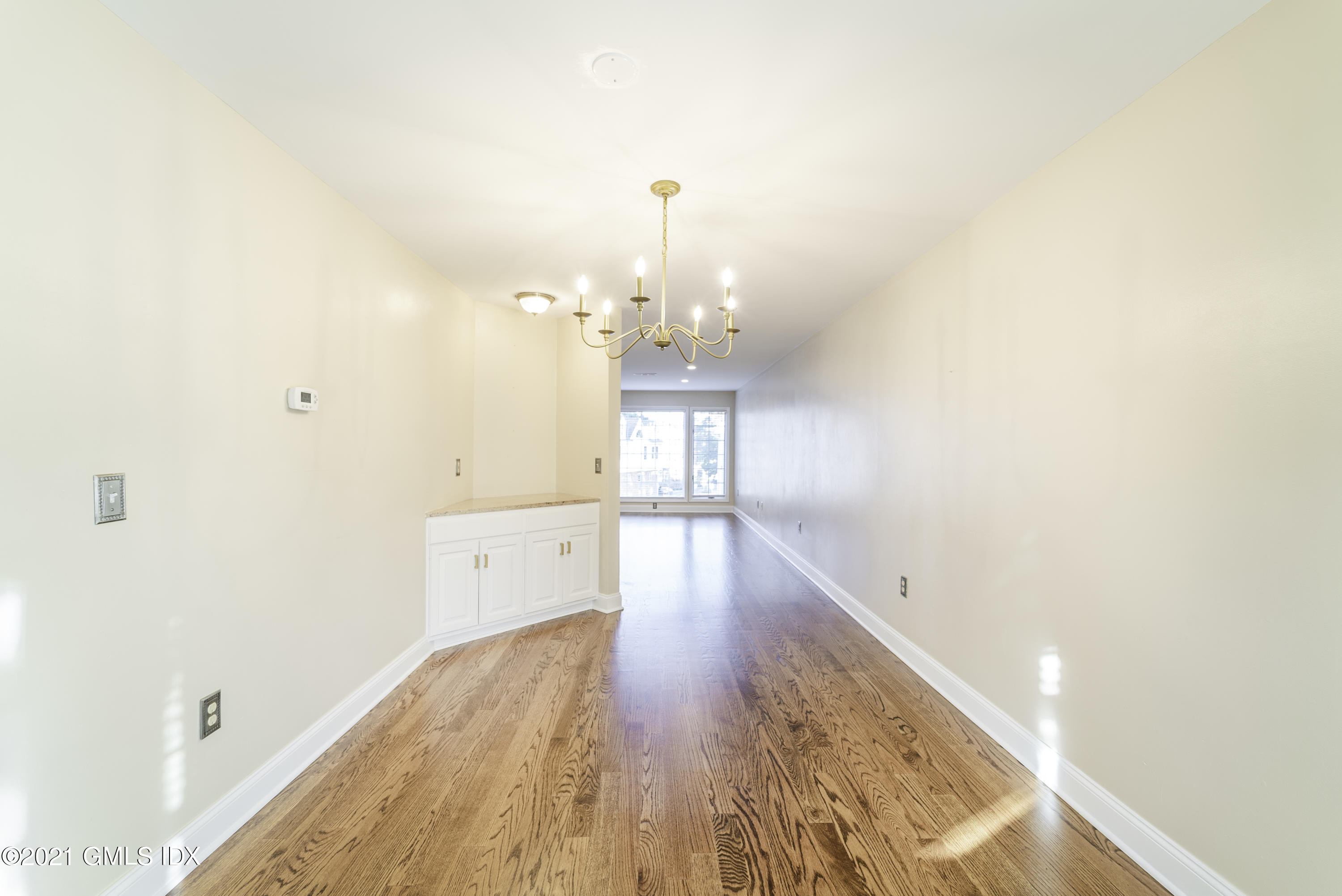 150 Prospect Street, Unit 23 Greenwich, CT 06830 - Photo 6 of 20 a view of a kitchen with wooden floor and a large window