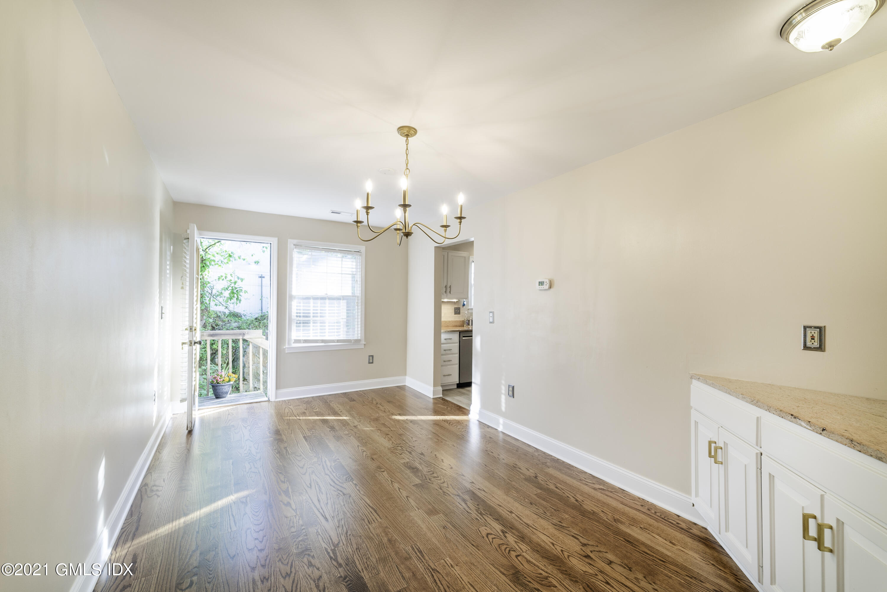 150 Prospect Street, Unit 23 Greenwich, CT 06830 - Photo 7 of 20 a view of a livingroom with wooden floor and a ceiling fan