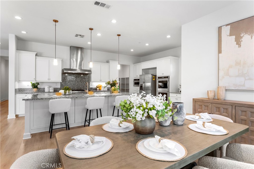 105 Shear Irvine, CA 92618 - Photo 12 of 35 a view of kitchen with white cabinets and chairs