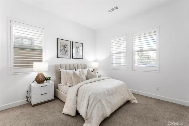 a bed room with two bed and a window