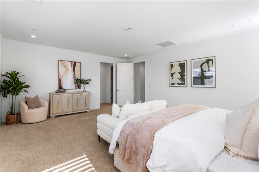 105 Shear Irvine, CA 92618 - Photo 23 of 35 a spacious bedroom with a bed and a couch