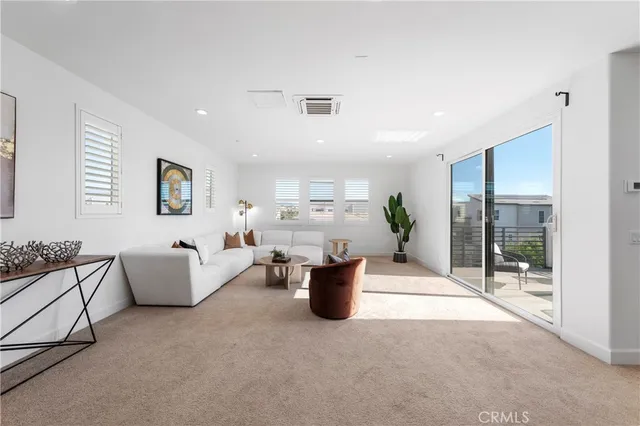 a living room with furniture and white walls