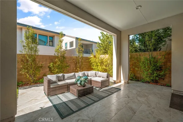 a living room with furniture and a floor to ceiling window