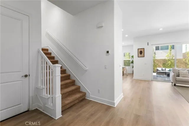 a view of a hallway with furniture and wooden floor