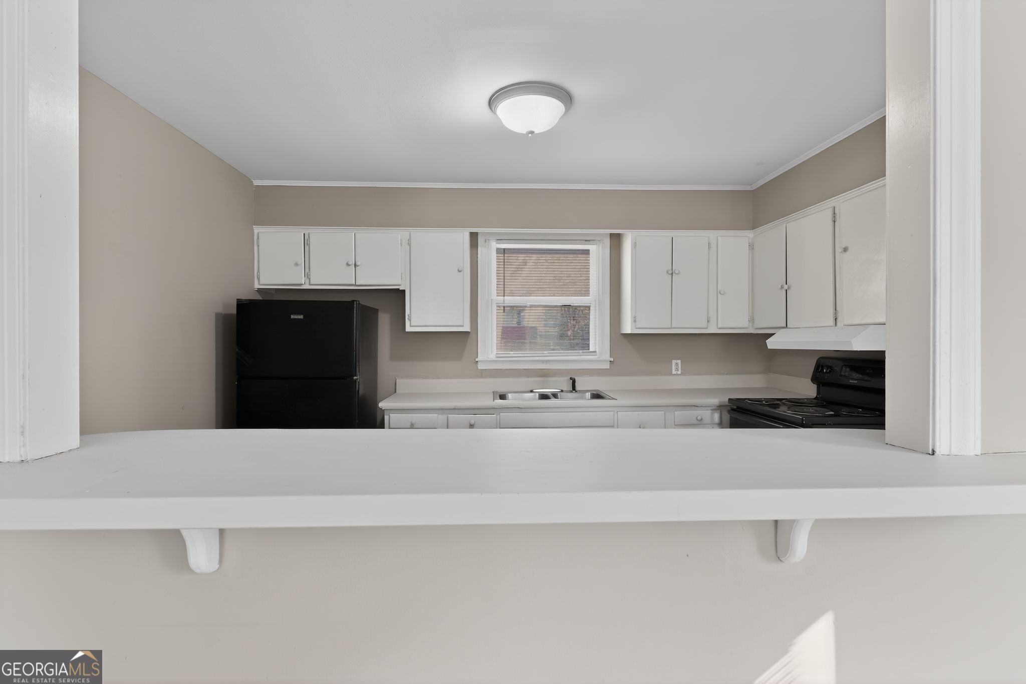 2835 Fairmount Street Augusta, GA 30906 - Photo 10 of 30 a kitchen with granite countertop white cabinets and black stainless steel appliances