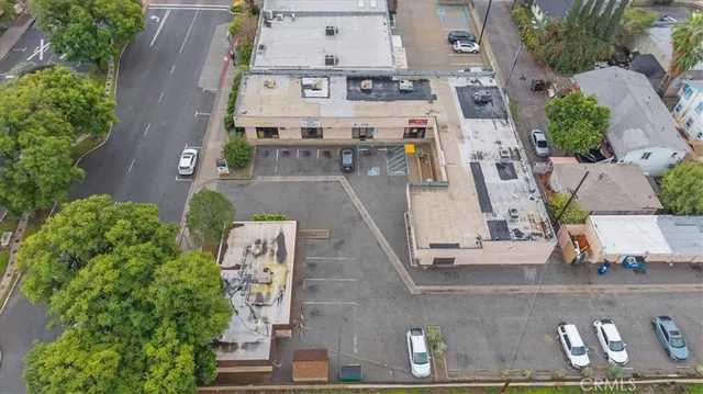 an aerial view of residential houses with outdoor space and street view