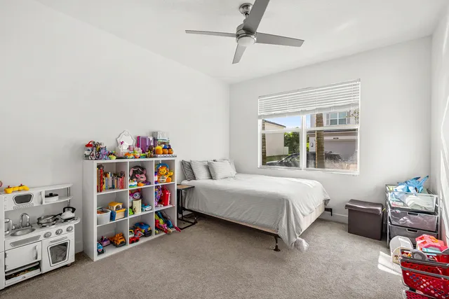 a bedroom with bed and a window