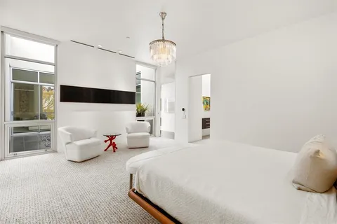 a bedroom with a bed and a chandelier