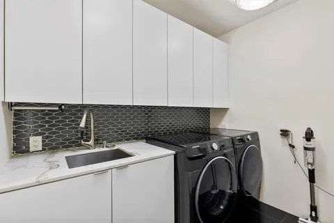 a view of a storage and utility room with washer and dryer