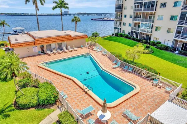 a view of a swimming pool with a lawn chairs