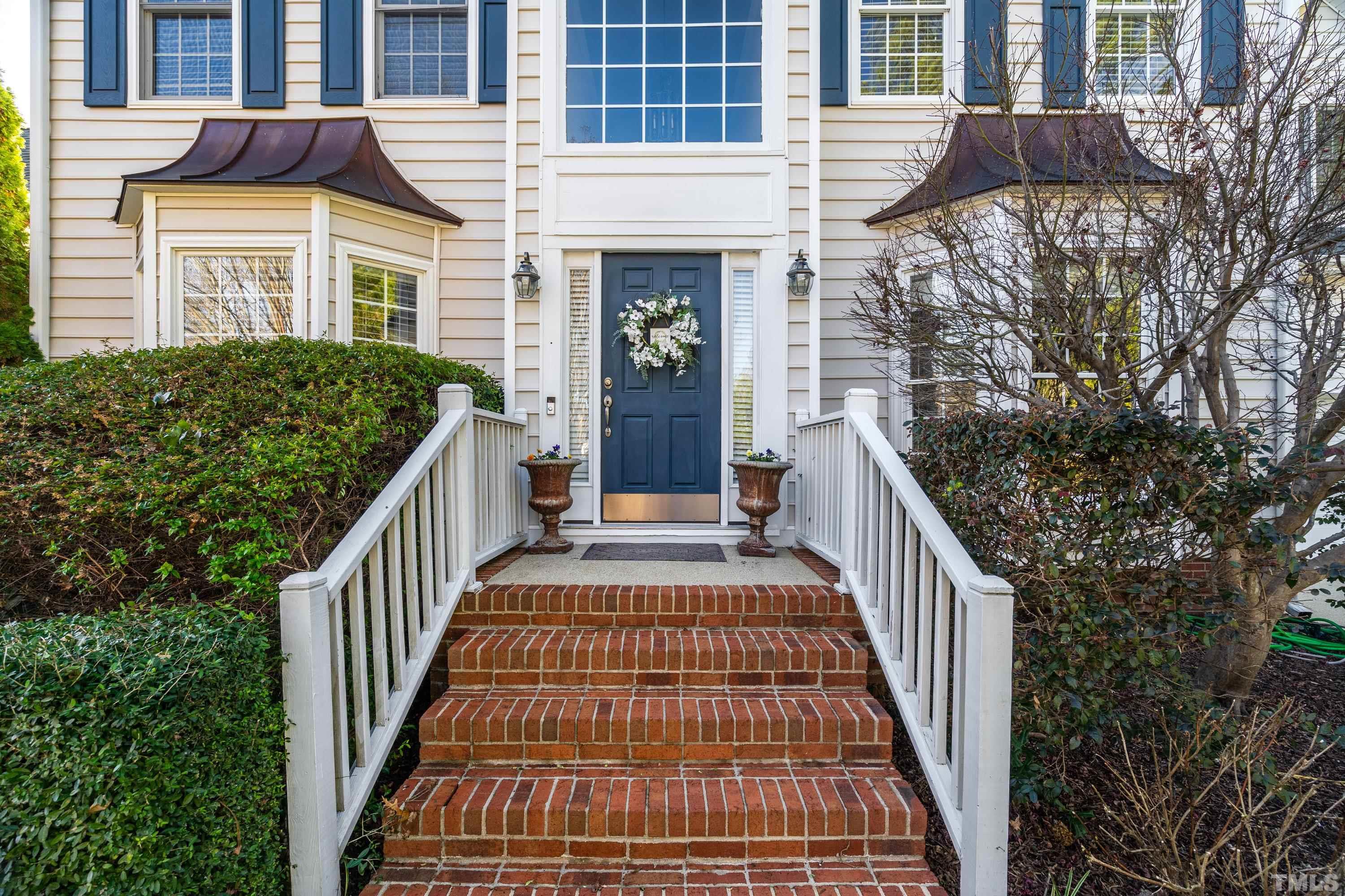 7405 Dorrington Trail Raleigh, NC 27615 - Photo 2 of 31 a view of a brick house with wooden stairs