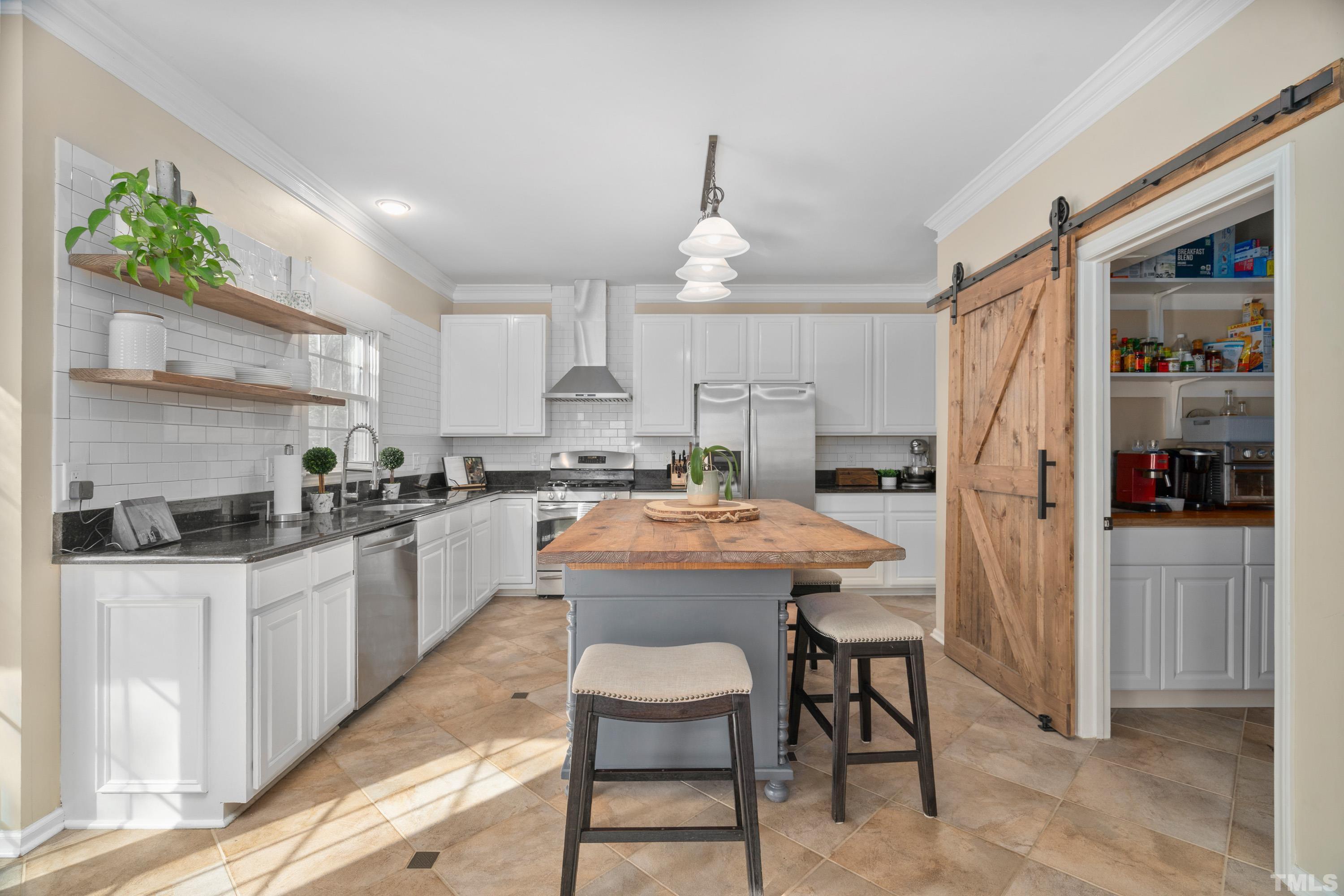 7405 Dorrington Trail Raleigh, NC 27615 - Photo 12 of 31 a kitchen with granite countertop a sink stainless steel appliances and cabinets