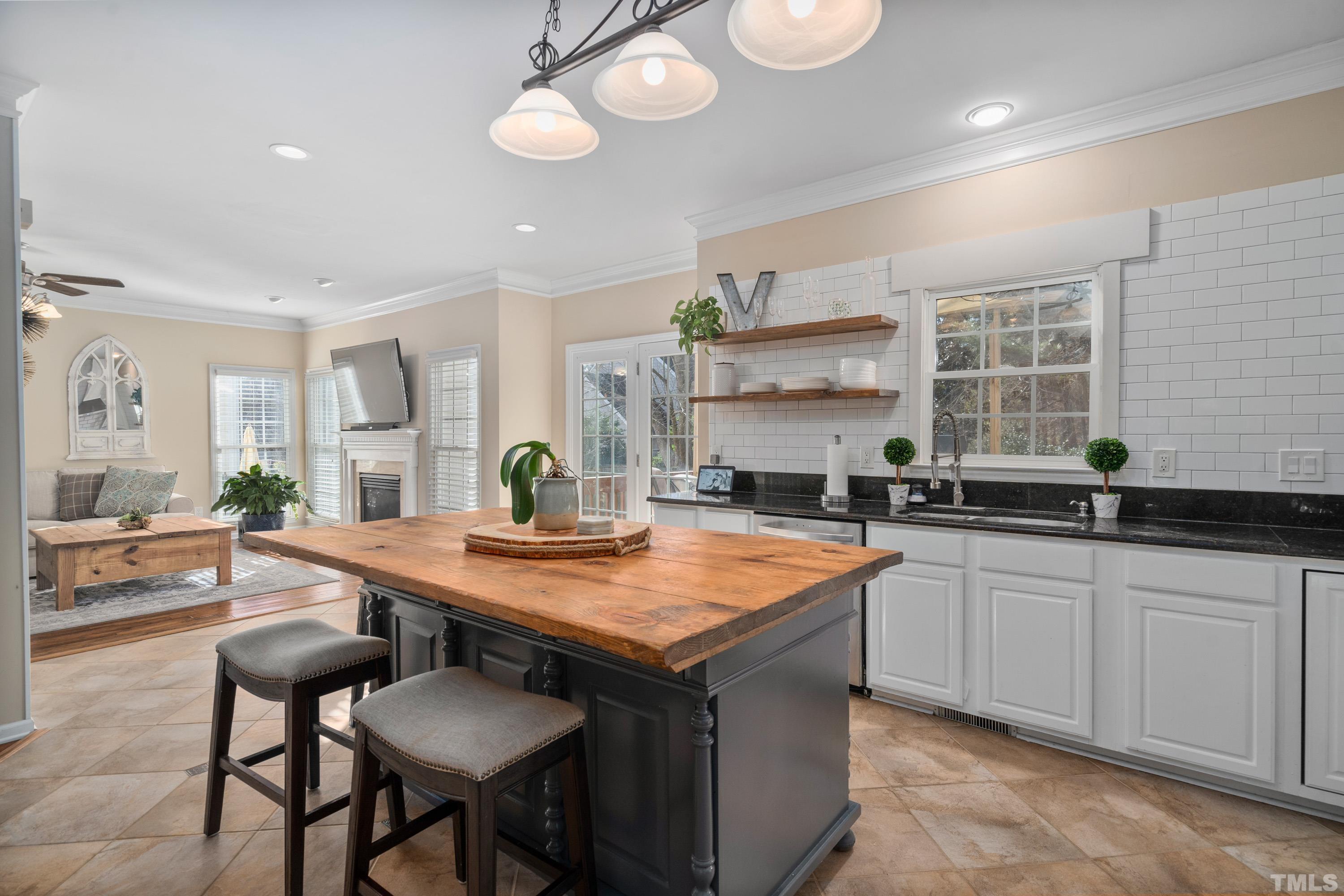 7405 Dorrington Trail Raleigh, NC 27615 - Photo 14 of 31 a kitchen with stainless steel appliances granite countertop a sink and a stove
