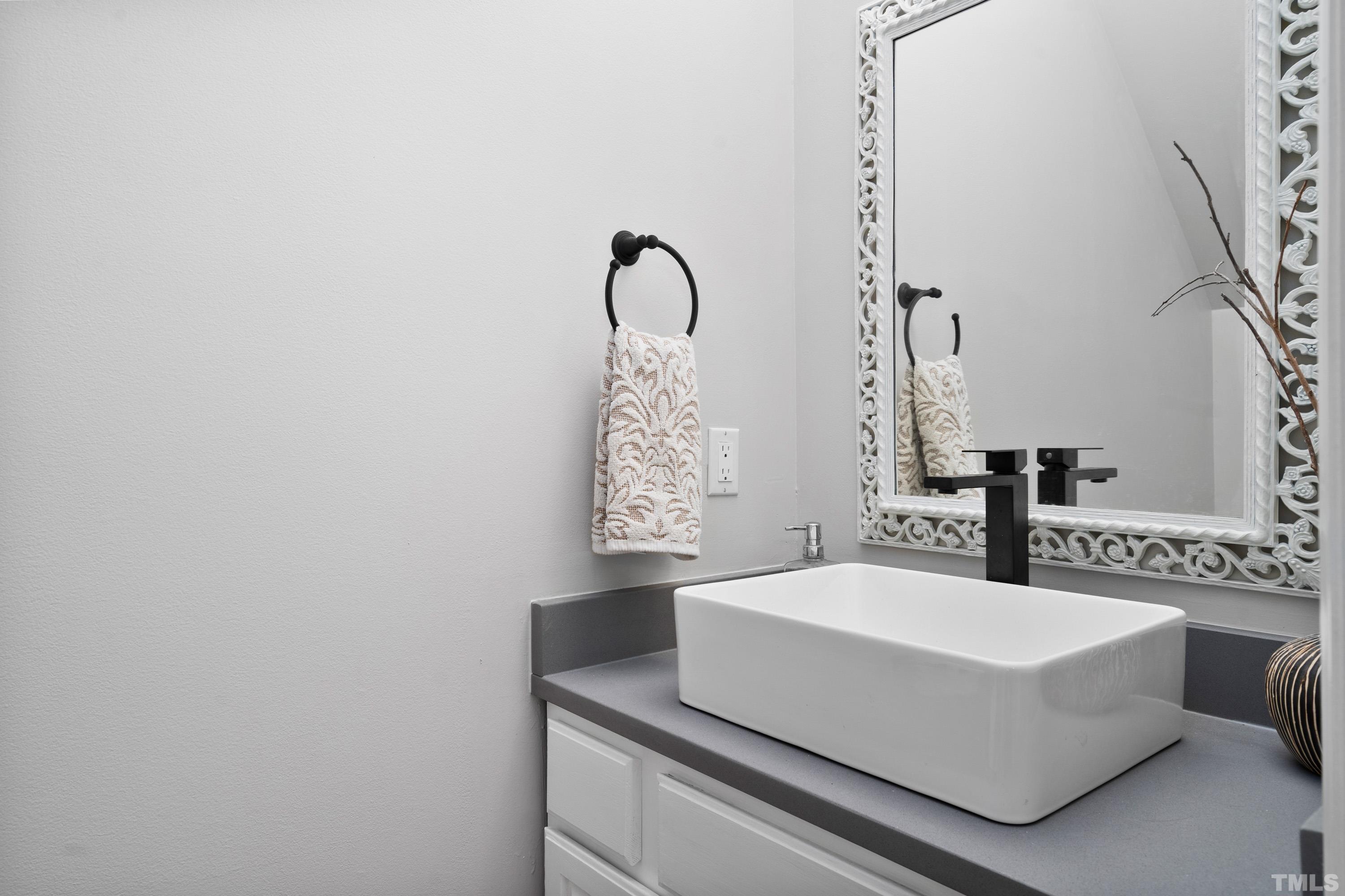 7405 Dorrington Trail Raleigh, NC 27615 - Photo 17 of 31 a bathroom with a sink and a mirror