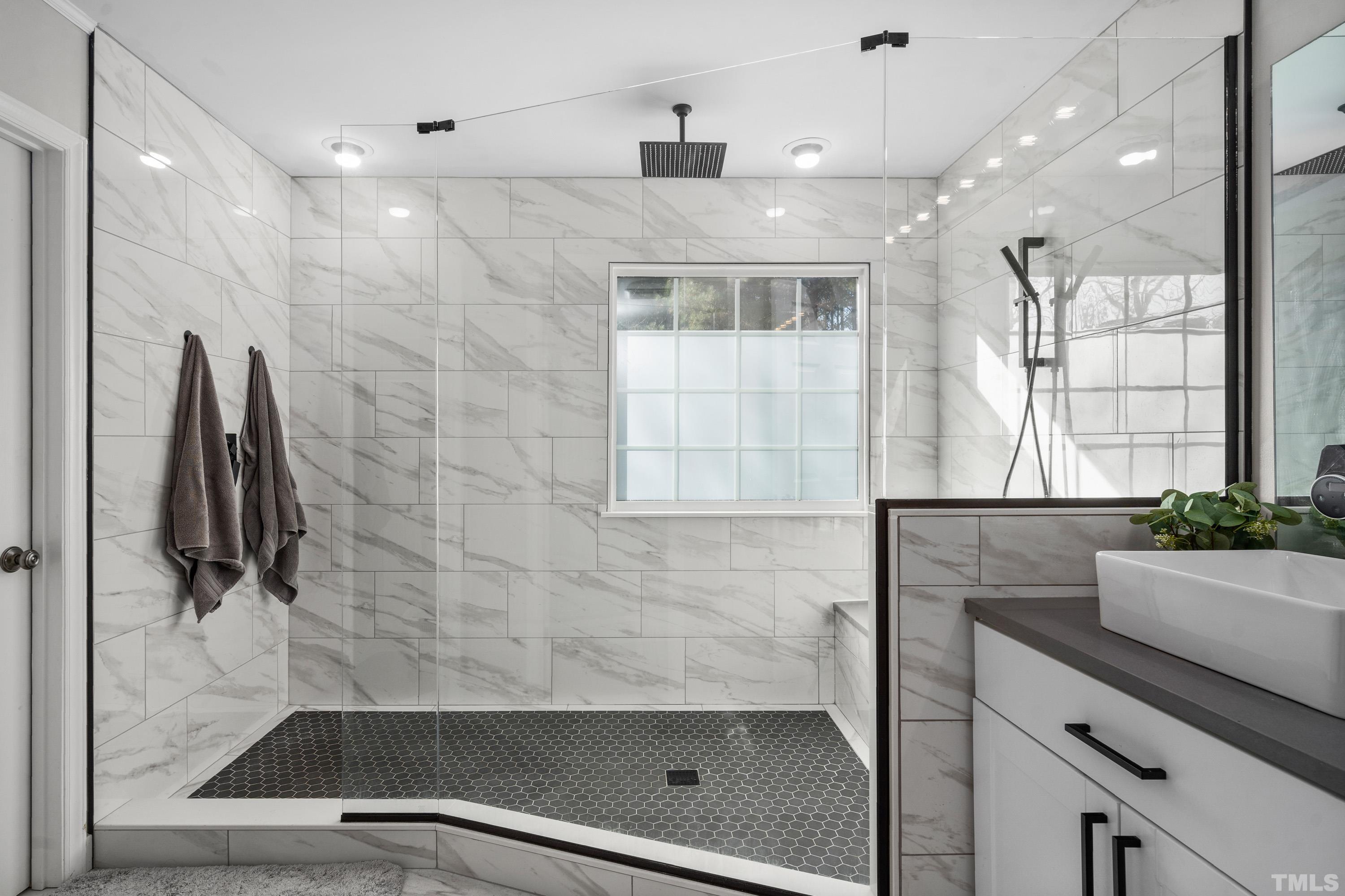 7405 Dorrington Trail Raleigh, NC 27615 - Photo 20 of 31 a view of a bathroom with a shower and a sink