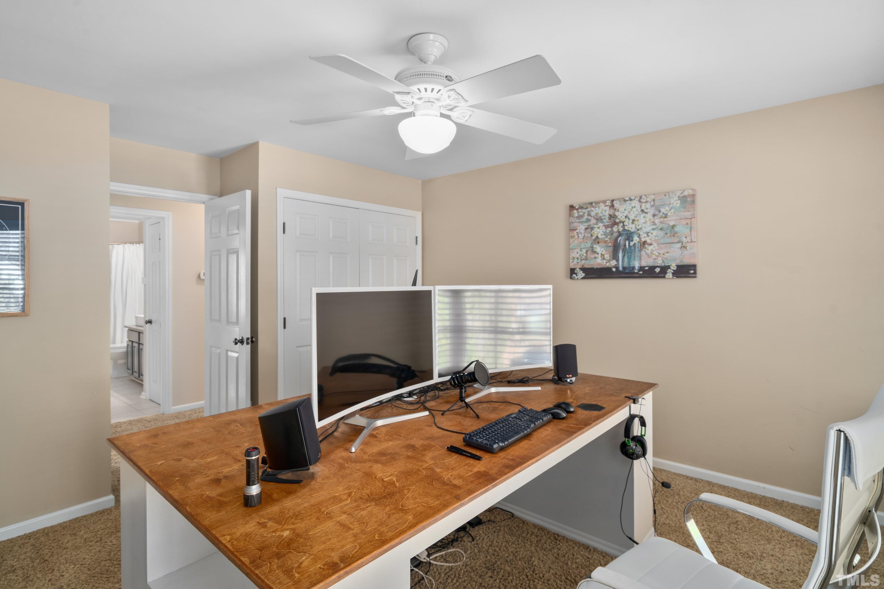 7405 Dorrington Trail Raleigh, NC 27615 - Photo 23 of 31 a room with table and flat screen tv