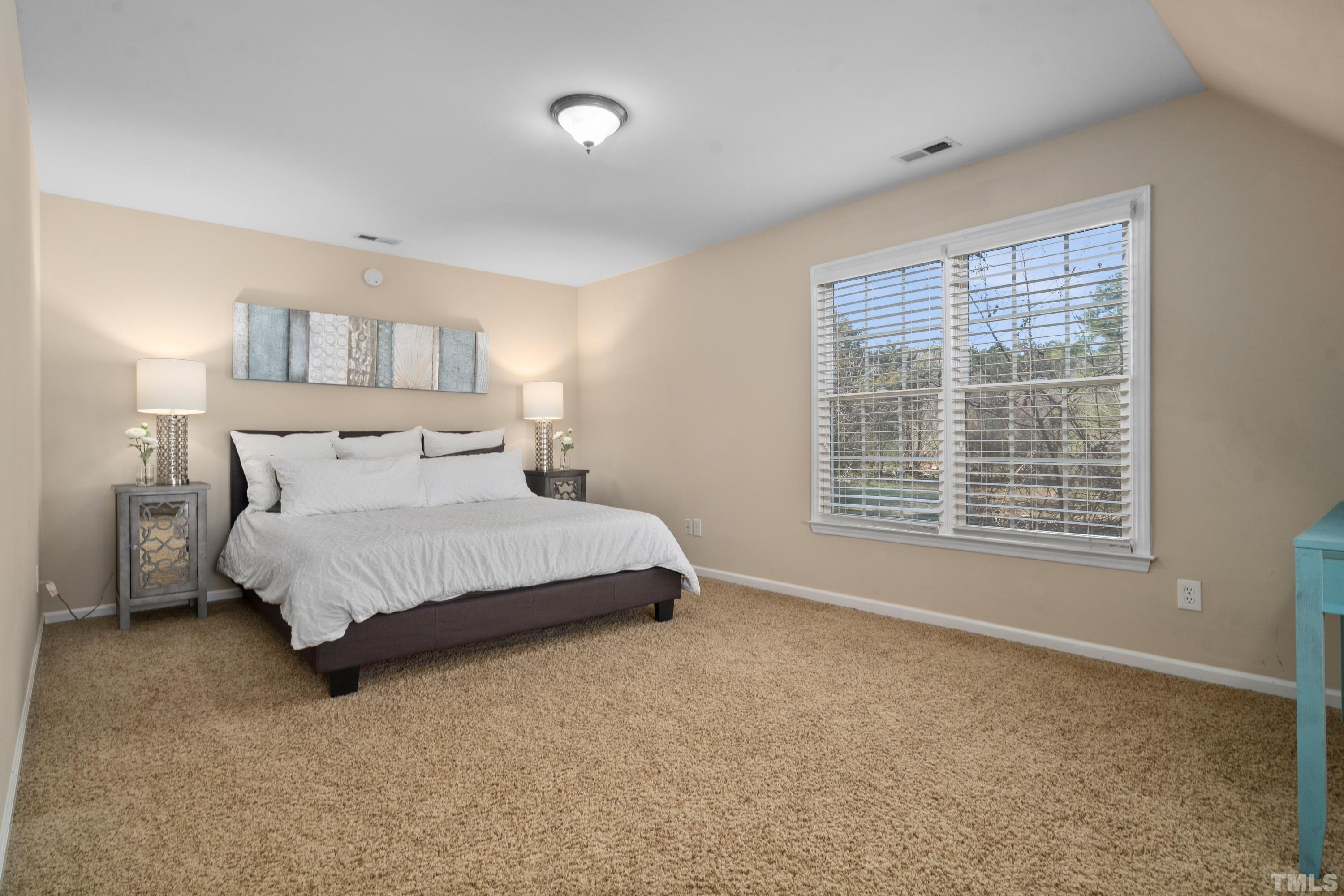 7405 Dorrington Trail Raleigh, NC 27615 - Photo 25 of 31 a bedroom with a bed and a window